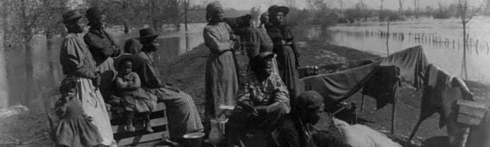Black families displaced during a flood, early 20th century photograph